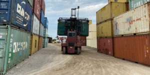 20ft shipping container being moved by forklift at intermodal depot, used shipping containers for sale, 20ft shipping containers for sale, wind and water tight shipping containers, wwt used shipping containers