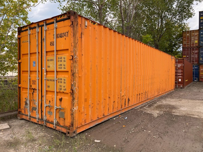 an orange shipping container with rust