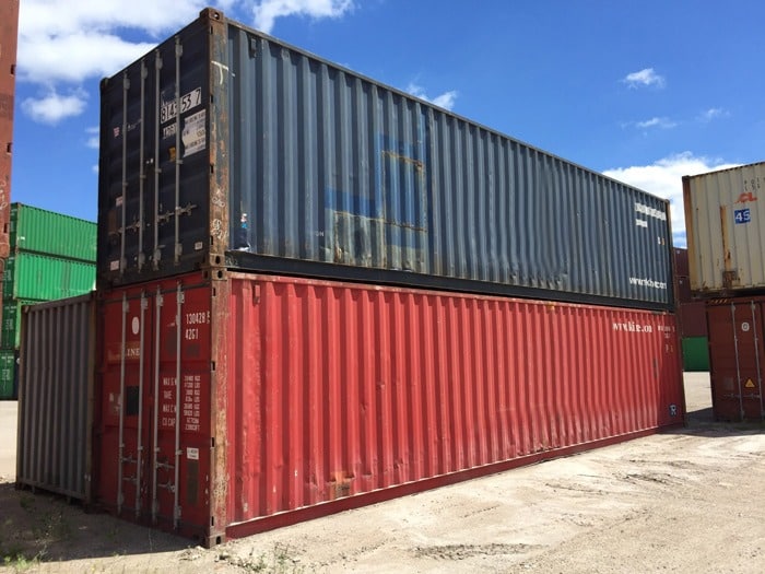a red and blue shipping container stacked