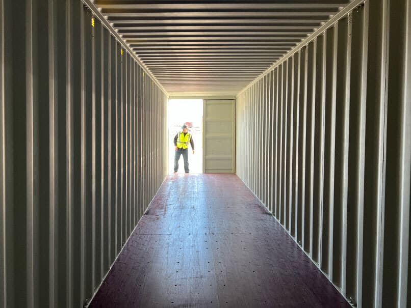 man looking into open shipping container